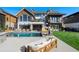 Luxury home exterior with pool and patio at 2599 Heron Lakes Pkwy, Berthoud, CO 80513