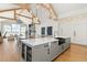 Modern kitchen with large island and high ceilings at 2599 Heron Lakes Pkwy, Berthoud, CO 80513