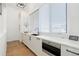 Bright kitchen featuring white cabinetry and a built-in microwave at 2599 Heron Lakes Pkwy, Berthoud, CO 80513