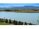 Stunning lake view with mountain backdrop and homes at 2599 Heron Lakes Pkwy, Berthoud, CO 80513