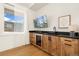 Modern wet bar with wine cooler in main bedroom at 2599 Heron Lakes Pkwy, Berthoud, CO 80513