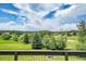 Expansive backyard featuring lush green space, mature trees, and beautiful views at 7614 Malamute Dr, Evergreen, CO 80439