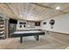 Finished basement with rustic wood accents, providing a cozy and inviting recreational space at 7614 Malamute Dr, Evergreen, CO 80439