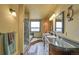 Bathroom featuring double vanity, glass enclosed shower and separate tub for ultimate relaxation at 7614 Malamute Dr, Evergreen, CO 80439