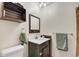Rustic bathroom with a dark wood vanity and decor at 7614 Malamute Dr, Evergreen, CO 80439