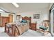 Comfortable bedroom with hardwood furniture and carpet at 7614 Malamute Dr, Evergreen, CO 80439
