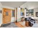 Inviting entryway featuring a rustic wooden door, slate floors, and a cozy seating area by bright windows at 7614 Malamute Dr, Evergreen, CO 80439