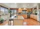 Spacious kitchen featuring a large island, stainless steel appliances, and wood floors at 7614 Malamute Dr, Evergreen, CO 80439