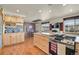 Modern kitchen with stainless steel appliances, wooden cabinets and adjoining dining area at 7614 Malamute Dr, Evergreen, CO 80439