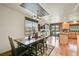 Cozy kitchen and dining room with hardwood floors, island and breakfast bar at 7614 Malamute Dr, Evergreen, CO 80439