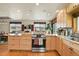 Kitchen with stainless steel appliances and wooden cabinets at 7614 Malamute Dr, Evergreen, CO 80439