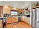 Well-equipped kitchen with stainless steel appliances, wooden cabinets and hardwood floors at 7614 Malamute Dr, Evergreen, CO 80439