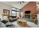 Comfortable living room with stone fireplace, large windows offering expansive views of the surrounding landscape at 7614 Malamute Dr, Evergreen, CO 80439