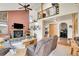 Cozy living room with a stone fireplace, rustic wood accents, and comfortable seating, creating a welcoming atmosphere at 7614 Malamute Dr, Evergreen, CO 80439