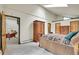 Bright main bedroom featuring vaulted ceiling with skylight and natural wood doors and trim at 7614 Malamute Dr, Evergreen, CO 80439