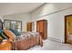 Cozy main bedroom with neutral walls and large windows, offering ample natural light and scenic views at 7614 Malamute Dr, Evergreen, CO 80439