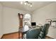 Dedicated home office with hardwood floors, professional decor, and ample space at 7614 Malamute Dr, Evergreen, CO 80439