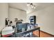 Spacious office with built in shelving, lots of natural light, and black office furniture at 7614 Malamute Dr, Evergreen, CO 80439