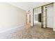 Carpeted bedroom with closet and a door leading to a balcony overlooking the cityscape at 1020 15Th St # 13K, Denver, CO 80202