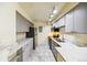 Charming kitchen with updated stainless steel appliances, grey cabinets, and marble countertops at 1020 15Th St # 13K, Denver, CO 80202