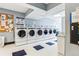 Bright laundry room featuring multiple high-efficiency washing machines and coin-operated payment system at 1020 15Th St # 13K, Denver, CO 80202