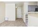 Spacious living room with carpet flooring, white walls, and an entrance door at 1020 15Th St # 13K, Denver, CO 80202