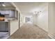Spacious living room with neutral carpet flooring, updated lighting, and access to a balcony at 1020 15Th St # 13K, Denver, CO 80202