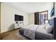 Nicely decorated bedroom featuring a gray bed, TV, a sliding glass door, and carpet at 1020 15Th St # 13K, Denver, CO 80202