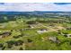 Aerial view of the property showcasing vast acreage, a central home, and a large outbuilding at 16710 Vincent Ave, Monument, CO 80132