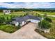 Aerial view of the home showcasing mature trees, three-car garage, and lush landscaping at 16710 Vincent Ave, Monument, CO 80132