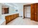 Bright bathroom featuring double sinks, wood cabinetry, and a spacious closet at 16710 Vincent Ave, Monument, CO 80132