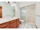 Bathroom featuring wood cabinetry, a shower, and attractive tile floors at 16710 Vincent Ave, Monument, CO 80132