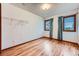 Cozy bedroom with hardwood floors and two large windows offering bright natural light at 16710 Vincent Ave, Monument, CO 80132