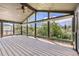 Enclosed deck with vaulted ceiling and large windows offering scenic views of the surrounding landscape at 16710 Vincent Ave, Monument, CO 80132