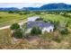A closer elevated view of the home, highlighting the landscaping, neutral stucco, and stone details around the property at 16710 Vincent Ave, Monument, CO 80132