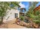 Exterior rear view of home with a pond, pergola, water feature, and lush landscaping at 16710 Vincent Ave, Monument, CO 80132