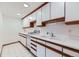 Functional kitchen featuring white cabinets with wood trim and classic appliances at 16710 Vincent Ave, Monument, CO 80132
