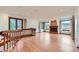 Sunlit living room with wood floors, staircase, a fireplace, and views of the surrounding property from multiple windows at 16710 Vincent Ave, Monument, CO 80132