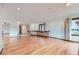 Spacious living room showcasing hardwood floors and a window with curtains, offering an airy and bright ambiance at 16710 Vincent Ave, Monument, CO 80132