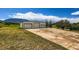 Large metal outbuilding with multiple roll-up doors and an expansive concrete apron at 16710 Vincent Ave, Monument, CO 80132