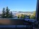 Inviting balcony featuring a charming bistro set with a picturesque view of the lush landscape and distant mountains at 386 Monte Vista Rd, Golden, CO 80401