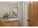 Bathroom features a vessel sink, oak cabinets, and tile floor at 386 Monte Vista Rd, Golden, CO 80401