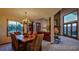 Elegant dining room with an antler chandelier, large windows, and rustic decor at 386 Monte Vista Rd, Golden, CO 80401