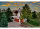 Charming two-story home with a two-car garage, balcony, mature trees, and a beautiful sunset sky at 386 Monte Vista Rd, Golden, CO 80401