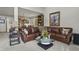 Spacious living room with large leather couch and a table featuring a flower arrangement at 386 Monte Vista Rd, Golden, CO 80401