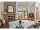 Cozy living room with stone fireplace, large windows with great view, and stylish furnishings at 386 Monte Vista Rd, Golden, CO 80401