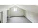 Room features gray carpet flooring, slanted walls, and a window at 6104 Hudson St, Commerce City, CO 80022