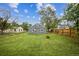 Lush backyard features a well-manicured lawn and a vintage fire pit at 6104 Hudson St, Commerce City, CO 80022