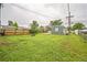 Expansive backyard with lush lawn, fire pit, and detached garage at 6104 Hudson St, Commerce City, CO 80022