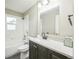 Bright bathroom features a shower and tub combination, and a vanity with a stylish countertop and modern fixtures at 6104 Hudson St, Commerce City, CO 80022
